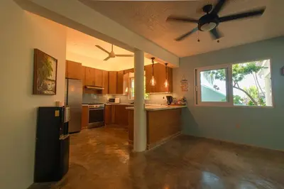 a kitchen with a ceiling fan and a refrigerator at The SeaDog Inn-Oceanfront Villa in Cabrera