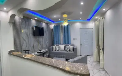 a living room with a couch and a tv at Moderna casa cerca de el aeropuerto SDQ y mi rent cars in La Caleta