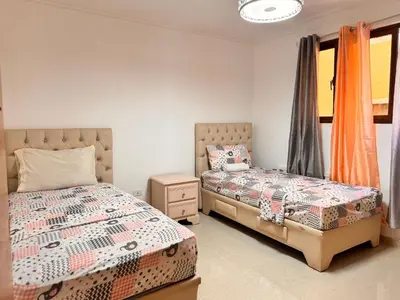 a bedroom with two twin beds and a window at Santiago Amazing 4bedrooms Apt for group, spectacular WIFI, close to all fun in Santiago de los Caballeros