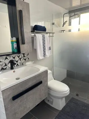 a bathroom with a white toilet and a sink at Espectacular apartamento IV Albatros byJu Juan Dolió in Villas del Mar