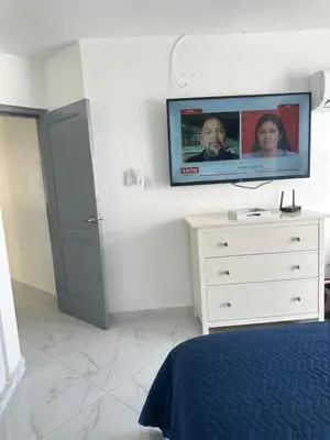a bedroom with a flat screen tv on top of a dresser at Espectacular apartamento IV Albatros byJu Juan Dolió in Villas del Mar