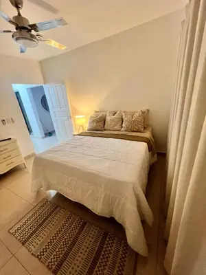 a bedroom with a bed and a ceiling fan at Hermosa villa frente al mar in San Felipe de Puerto Plata