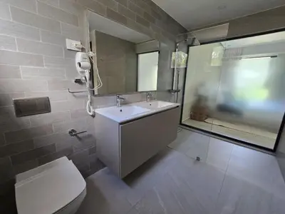 a bathroom with a sink and a toilet and a mirror at Apartamento a estrenar con acceso privado a la playa in Punta Cana