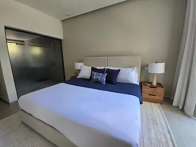 a bedroom with a large white bed with pillows at Apartamento a estrenar con acceso privado a la playa in Punta Cana