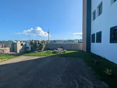 a building with a bench on the side of a road at Elegant apartment within a gated residential complex- 10 mins from Cabarete in Gaspar Hernández