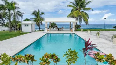 a swimming pool with a gazebo and the ocean at Oceanfront Escondido Bay Laguna Beach in Sosúa