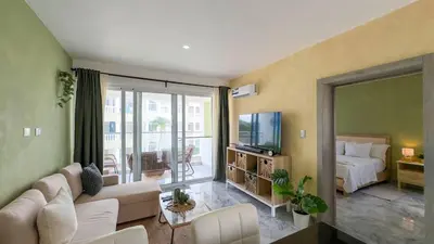 a living room with a couch and a bed at Oceanfront Escondido Bay Laguna Beach in Sosúa