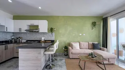 a kitchen and a living room with a pink couch at Oceanfront Escondido Bay Laguna Beach in Sosúa