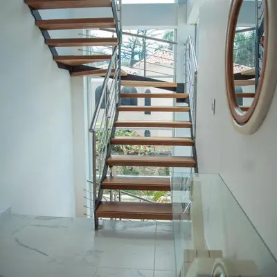 a spiral staircase in a house with a mirror at Caribbean getaway Villa 30 in Puerto Plata