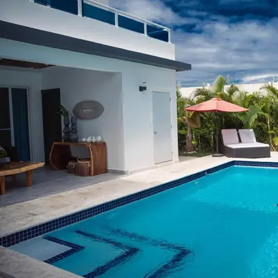 a villa with a swimming pool and a house at Caribbean getaway Villa 30 in Puerto Plata