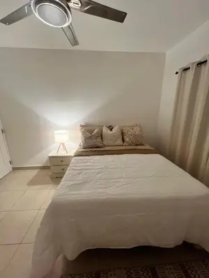 a bedroom with a bed with a ceiling fan at Paraiso frente al mar in San Felipe de Puerto Plata