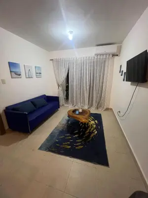 a living room with a blue couch and a table at Antares II in San Isidro