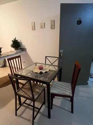 a glass table with two chairs and a table with a bowl on it at Antares II in San Isidro
