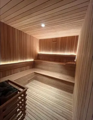 an empty sauna with a wooden at Luxury 2-Bed Condo in Piantini Sauna, Gym, & Pool in Santo Domingo