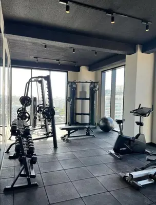 a gym with treadmills and equipment in a building at Luxury 2-Bed Condo in Piantini Sauna, Gym, & Pool in Santo Domingo