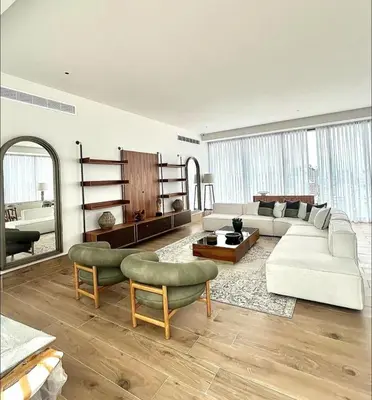 a living room with a white couch and chairs at Luxury 2-Bed Condo in Piantini Sauna, Gym, & Pool in Santo Domingo