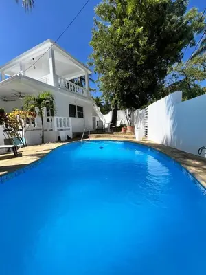 a large blue swimming pool in front of a house at ocean view tropical in Maggiolo