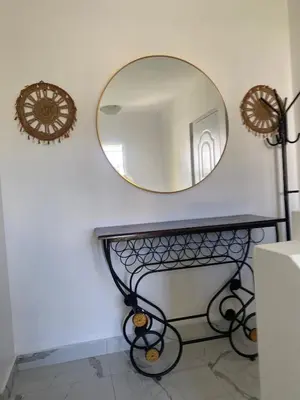 a mirror on a wall next to a black table at Luxury Villa in Muñoz, Puerto Plata in Puerto Plata