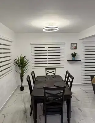 a dining room with a black table and chairs at Luxury Villa in Muñoz, Puerto Plata in Puerto Plata