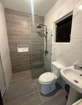 a bathroom with a shower and a toilet and a sink at Luxury Villa in Muñoz, Puerto Plata in Puerto Plata