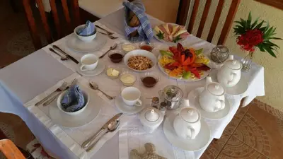 a table with a white table cloth with food on it at Ecolodge Vistamar in Los Patos