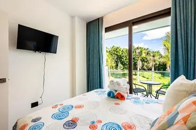 a bedroom with a bed with a teddy bear on it at Cana Rock Universe in Punta Cana