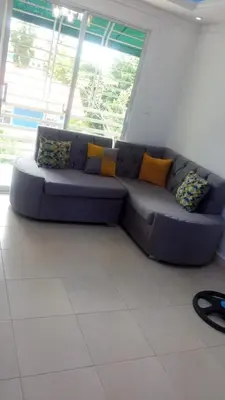 a blue couch in a room with a window at Alojamiento M&M in Los Paredones