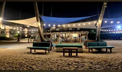 a tent with chairs and tables on the beach at night at Palmar Apartments Comfort Great Location in Punta Cana