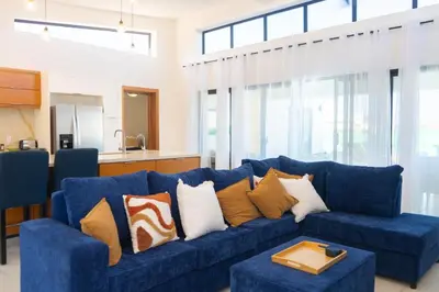 a blue couch with pillows in a living room at Newly Built Luxury Private 3 Bedroom Pool Villa in Sosúa