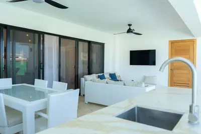 a kitchen and living room with a couch and a table at Newly Built Luxury Private 3 Bedroom Pool Villa in Sosúa
