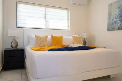 a white bed in a white bedroom with a window at Newly Built Luxury Private 3 Bedroom Pool Villa in Sosúa