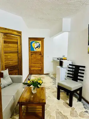 a living room with a couch and a table at La Cabañita de Jardín del Coco in Las Galeras
