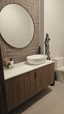 a bathroom with a sink and a large mirror at Luxury 2-Bed Condo in Piantini Sauna, Gym, and Pool in Santo Domingo