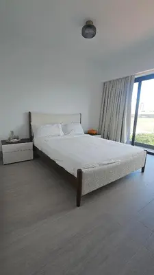 a bed in a bedroom with a large window at Luxury 2-Bed Condo in Piantini Sauna, Gym, and Pool in Santo Domingo