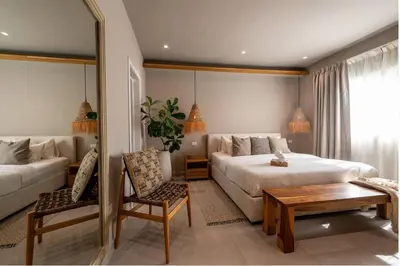 a bedroom with a bed and a couch and a table at New* 3BR Loft | Pool | Patio | 2 mins to Beach in Las Terrenas