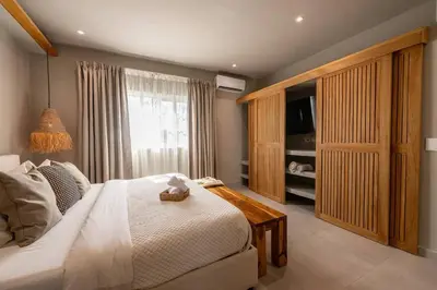 a bedroom with a bed and a large window at New* 3BR Loft | Pool | Patio | 2 mins to Beach in Las Terrenas