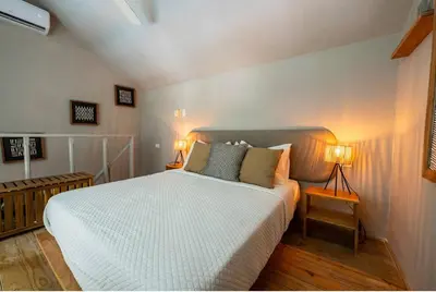 a bedroom with a white bed with two lamps at New* 3BR Loft | Pool | Patio | 2 mins to Beach in Las Terrenas