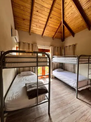 two bunk beds in a room with wooden ceilings at Villa Orquidea in Buena Vista