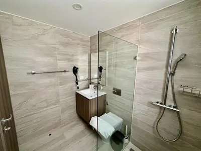 a bathroom with a shower and a toilet and a sink at Corner 2BDR in Coral Bay 2 in front of Hard Rock in Punta Cana
