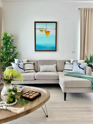 a living room with a couch and a coffee table at Corner 2BDR in Coral Bay 2 in front of Hard Rock in Punta Cana
