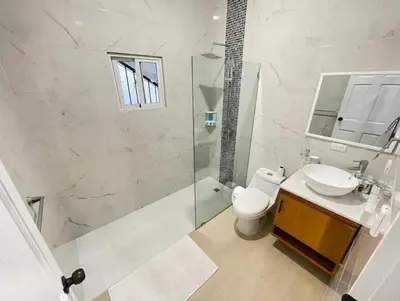 a bathroom with a shower and a toilet and a sink at Villa Ferrer I in Jarabacoa