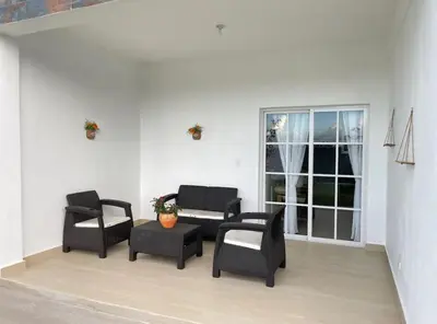 a living room with chairs and a table and a window at Villa Ferrer I in Jarabacoa