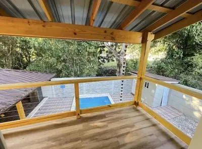 a screened in porch with a swimming pool at Villa Ferrer II in Jarabacoa
