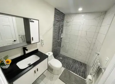 a bathroom with a toilet and a sink and a shower at Villa Ferrer II in Jarabacoa