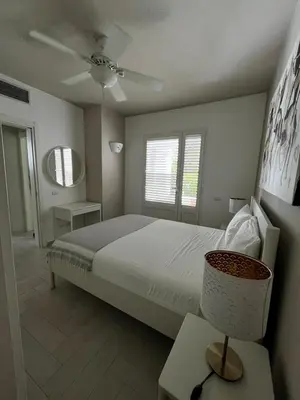 a bedroom with a bed and a ceiling fan at Luxury apartment Tracadero 2 Bedrooms Sea Pools access Private Garden Workspace in La Laguna