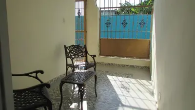 a room with two chairs and a window at Style and Comfort in Cancino