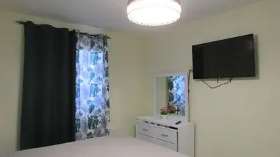 a bedroom with a bed and a flat screen tv at Style and Comfort in Cancino