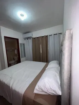 a bedroom with a large bed with white sheets at Comfortable apartment near the airport in La Javilla