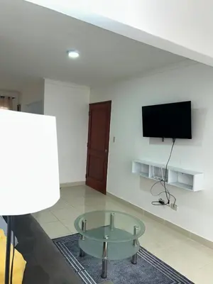a living room with a table and a flat screen tv at Comfortable apartment near the airport in La Javilla