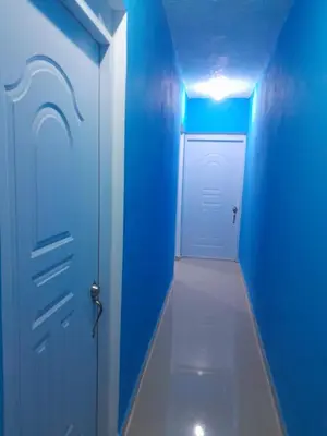 a blue hallway with a white door and a blue wall at Apartamentos La Mina in Manuel Chiquito